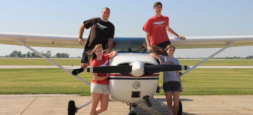 Students posing on QU Aviation plane